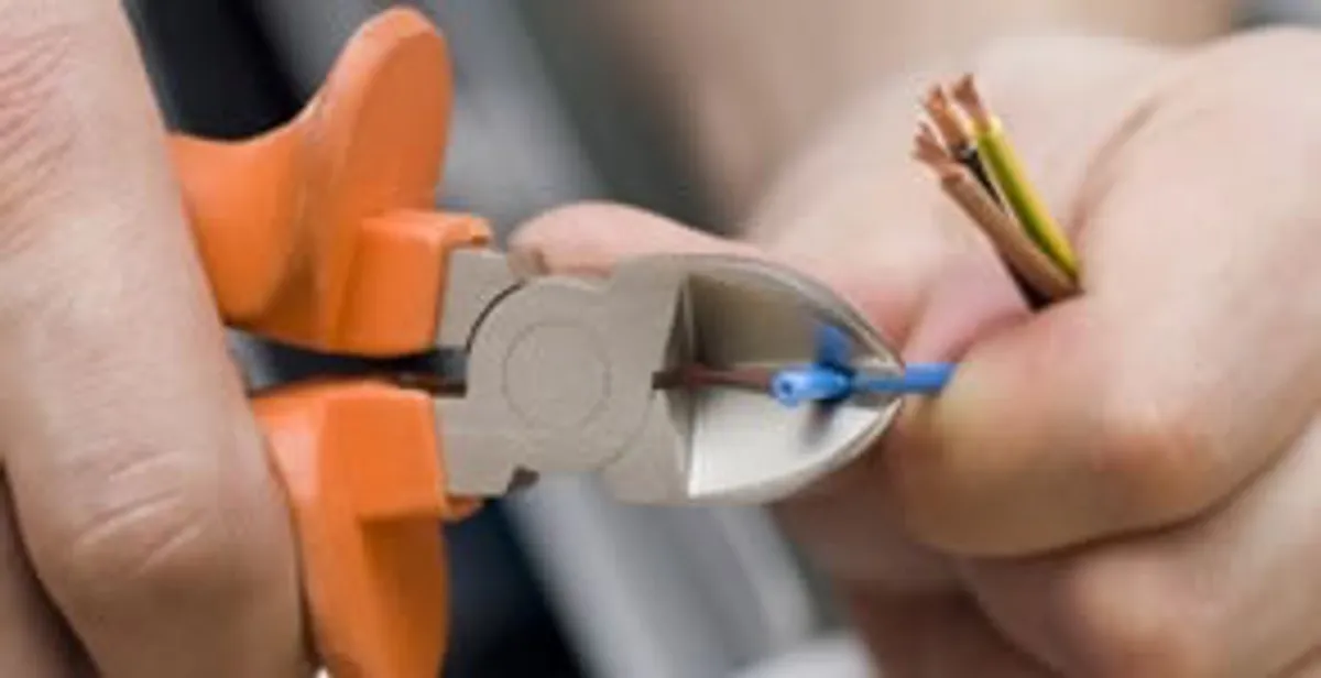 professional electrical services showing precise wire cutting by licensed electricians in Tucson, AZ
